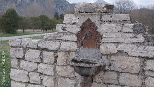 Antique cast iron wall fountain on rustic stone wall in the Italian countryside, Rocchetta a Volturno, Molise.