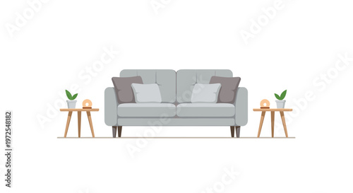 A comfortable grey fabric sofa with decorative pillows sits between two minimalist wooden side tables adorned with warm glowing lamps and small green potted plants.