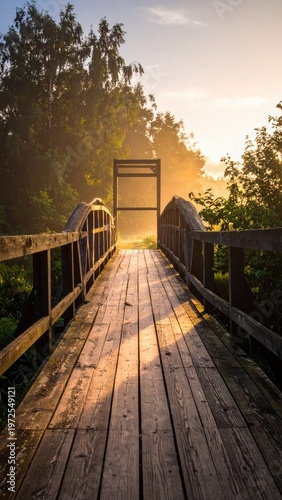 Wooden Bridge Over Pathway Surrounded by Lush Greenery at Sunrise
