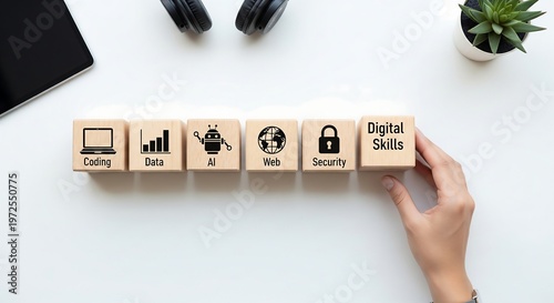 A hand arranges wooden blocks with icons representing digital skills like coding, data, AI, web, and security.