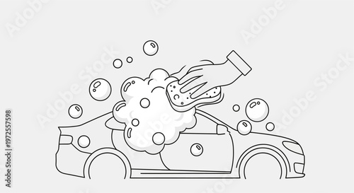A hand washing a car with soap.
