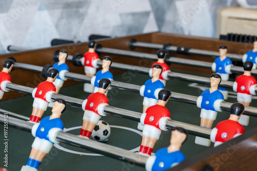 Foto Foosball table with players and ball in indoor game setup
