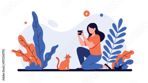 Young woman kneeling and using her smartphone to take a photograph of a cute small ginger cat surrounded by large plants.