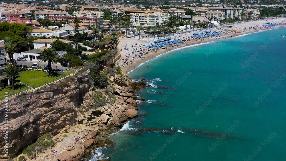 Fototapeta premium Aerial view of the spectacular sand beach of El Albir, with turquoise waters in the Mediterranean Spanish province of Alicante.