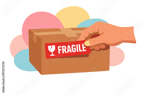 Canvastavla Hand applying fragile sticker to cardboard box for shipping.
