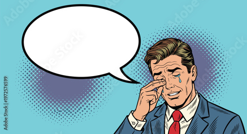 Emotional man in a suit crying and wiping his eyes with a large empty speech bubble for text on a blue background.
