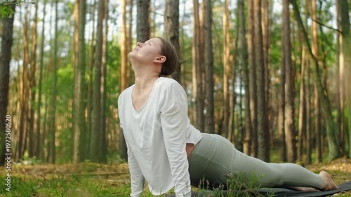 Woman meditates, relaxes and make yoga exercises in the woods alone