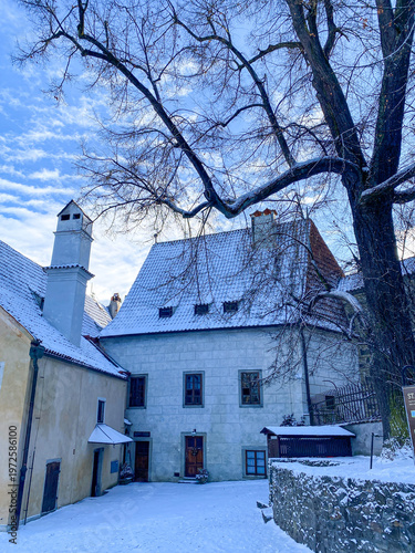 White snowy, fairy tale village, houses, castle and tower covered by snow in winter in Cesky Krumlov, UNESCO world heritage site in the South Bohemian region, Czech republic, Czechia - Cesky Krumlov C
