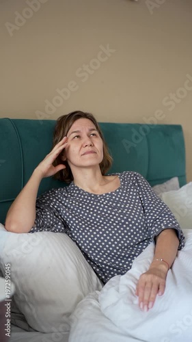 Blonde Mature Woman with Headache Feeling Exhausted and Burned Out in Bedroom