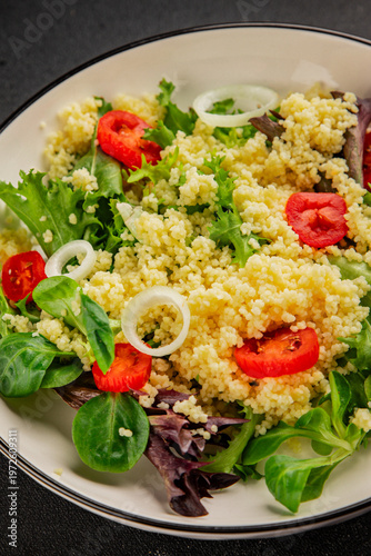 Принти на полотні Couscous salad vegetables tomato, onion, green lettuce leaves food preparation t