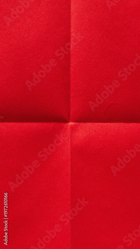Vertical folded scarlet red sheet, paper textured background with copy space for social media design