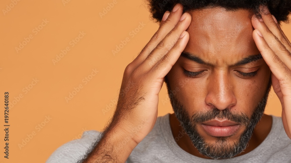 Fototapeta premium Contemplative Man with Head in Hands, Deep in Thought