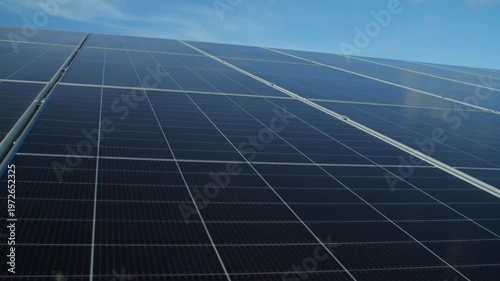 Solar Energy panel array in Solar Park Farm light capture technology blue sky lens flare