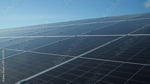 Solar Panel array Solar Farm Park long row of light energy capture technology blue sky stabilised gimbal