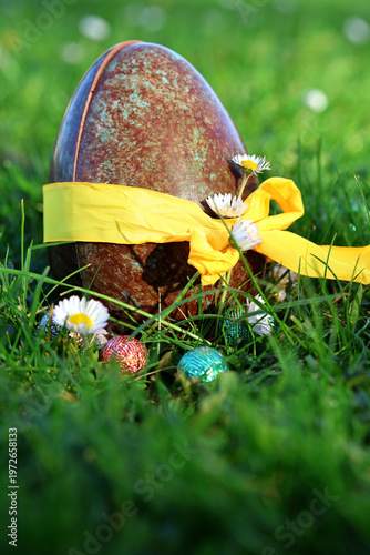 PARIS, FRANCE - APRIL 4, 2026: A large chocolate Easter egg hidden in the green grass. The Easter egg hunt tradition
