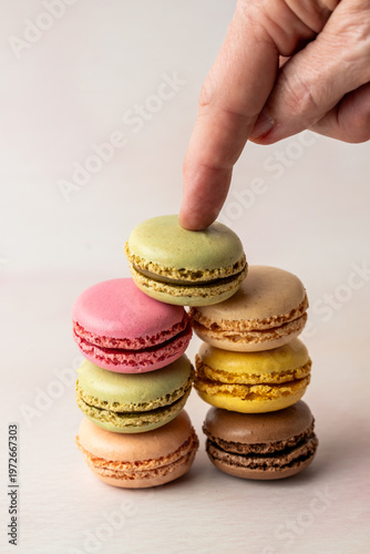 Stack of multi colored macaroons on a light surface 