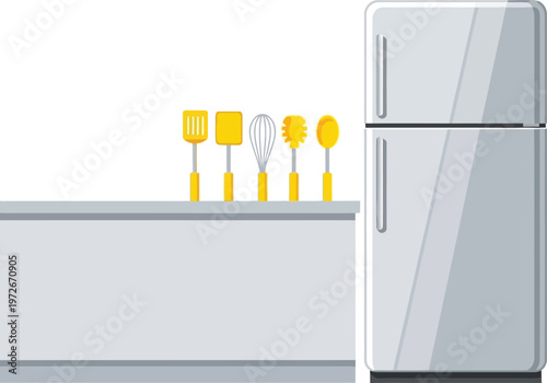 Modern kitchen countertop with cooking utensils and silver refrigerator