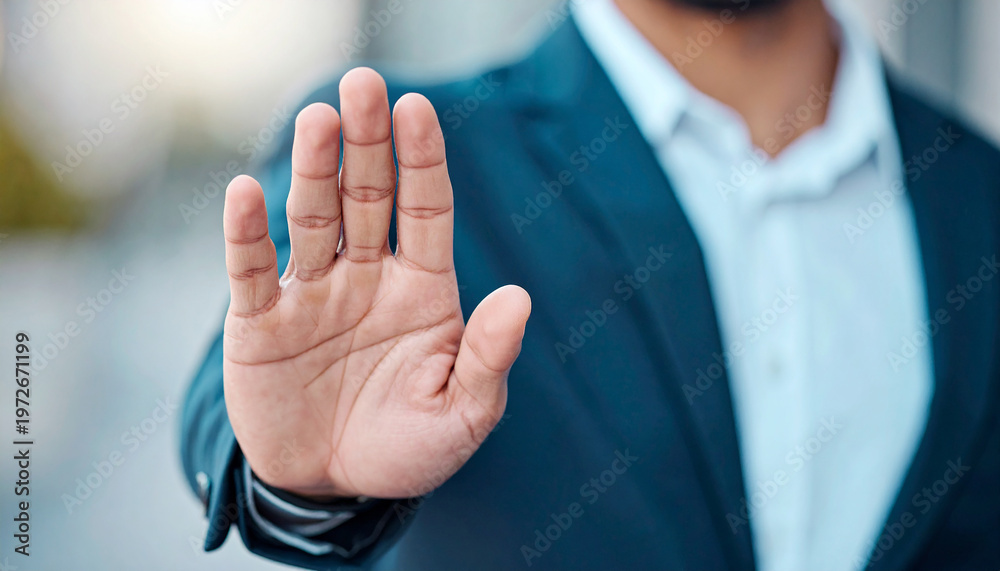 Obraz premium Hand of businessman showing stop, saying no or not accepting deal in an office at work. Male corporate worker not agreeing to statement or refusing