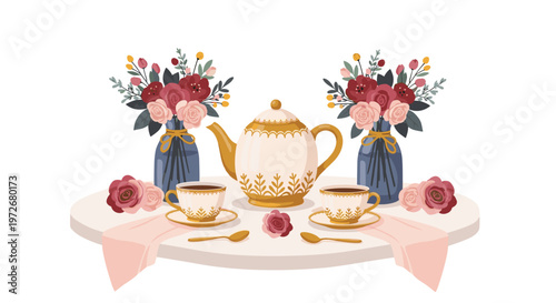 An exquisite white and gold patterned tea set for two sits on a round table flanked by lush bouquets of pink and red roses in blue vases against a white backdrop.