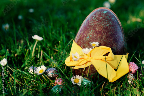 PARIS, FRANCE - APRIL 4, 2026: A large chocolate Easter egg hidden in the green grass. The Easter egg hunt tradition
