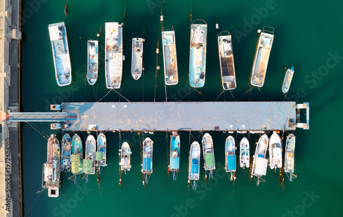 Fotografie Top view of fishing boats and yachts moored to the dock in a seaport on Naoshima