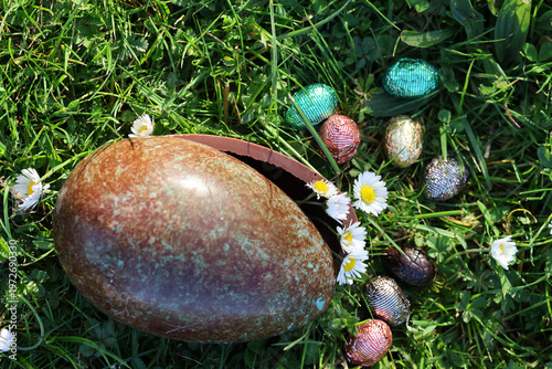PARIS, FRANCE - APRIL 4, 2026: A large chocolate Easter egg hidden in the green grass. The Easter egg hunt tradition
