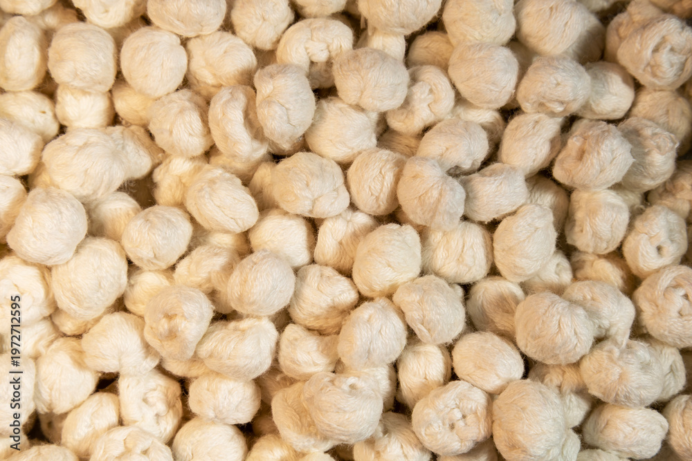 Fototapeta premium Natural silk cocoons texture closeup raw fiber organic material background