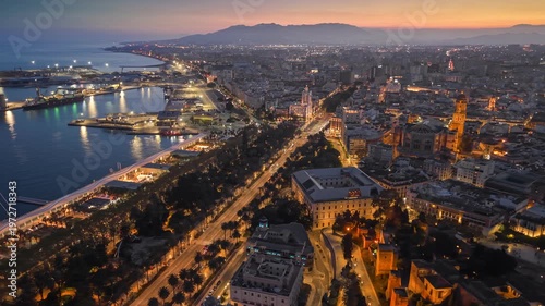 Wallpaper Mural Aerial view of Malaga city skyline at sunset with evening lights, stunning coastal panorama of Andalusia in Spain. Majestic twilight over Malaga port and the historic center with citylights Torontodigital.ca