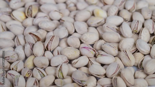 Detailed macro shot highlighting salted pistachio shells with crystals. An intricate macro image displaying pistachio shells coated with shimmering salt crystals
