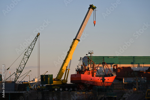 fishing boats in port, construction site with crane