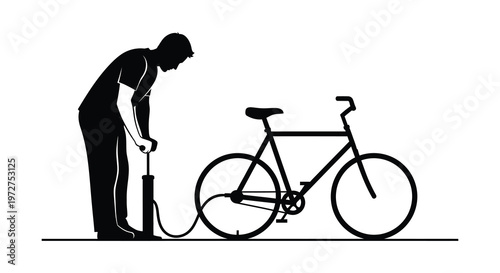 A man is inflating a bicycle tire with a pump creating a striking black and white image silhouette high quality professional