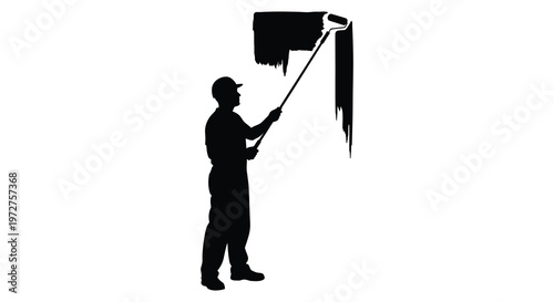 A painter applies a stroke of black paint to a wall creating a dramatic visual effect depicted as a silhouette