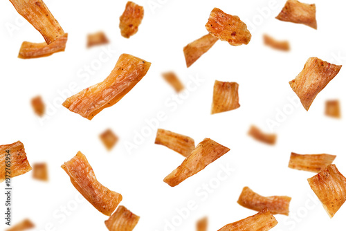 Falling chicken Jerky, dried meat isolated, selective focus