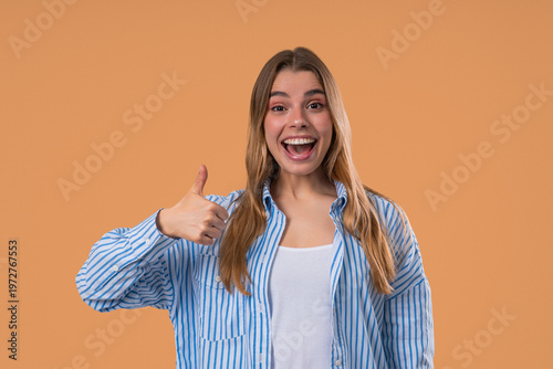 Happy woman gives thumbs up LIKE gesture with excitement and expressive approval