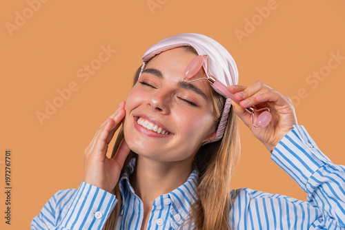 Charming Woman Doing Face Massage With Rose Quartz Stone Roller For Firmer Skin