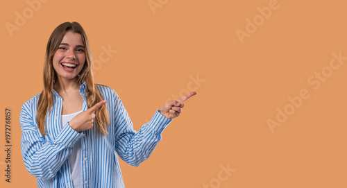 Happy Smiling Woman Presenting And Showing Something Isolated On Beige