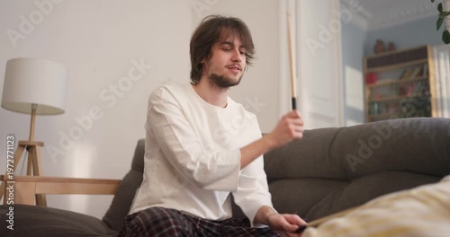A passionate drummer brings joy to a bright living room, creating vibrant rhythms during an inspiring morning session