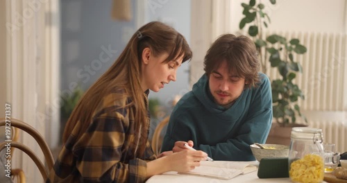 Two friends sit at a table, exchanging thoughts and enjoying each other's company in a warm and inviting space