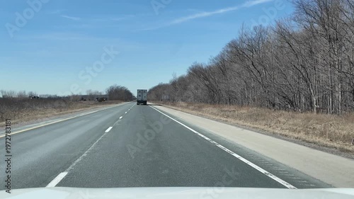 Truck Drives Down Highway in Spring Weather Without Other Cars Nearby