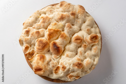 Bild auf Leinwand Round pinsa base isolated on white background, baked italian flatbread crust top
