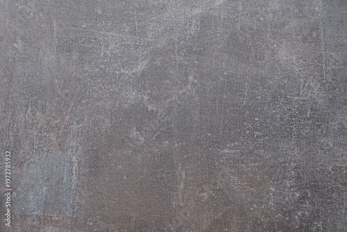 Close-up of rough, weathered metal surface with gray tones and visible scratches. Texture shows signs of aging, rust, or wear. Suitable for industrial, architectural