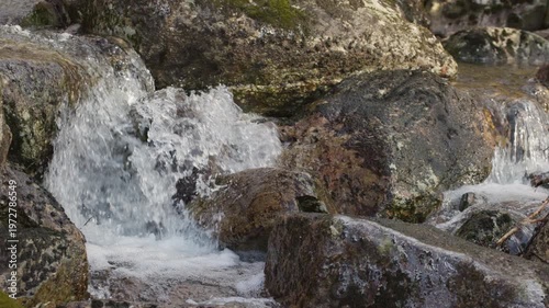 Waterfall Cascading Over Mossy Rocks.