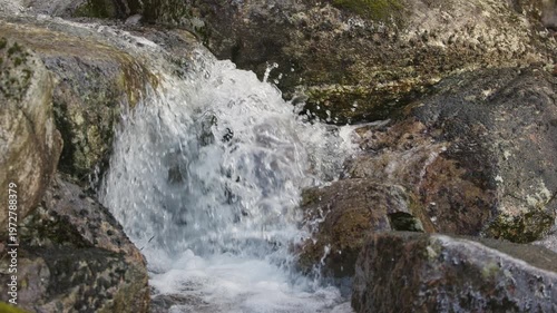 Waterfall Cascading Down Rocky Terrain.
