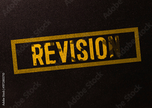 Conceptual revision symbol. REVISION word written on a pink sticker on a black stand on a white background.