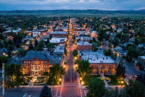 Aerial View of a Charming Small Town Street at Dusk with Illuminated Buildings.