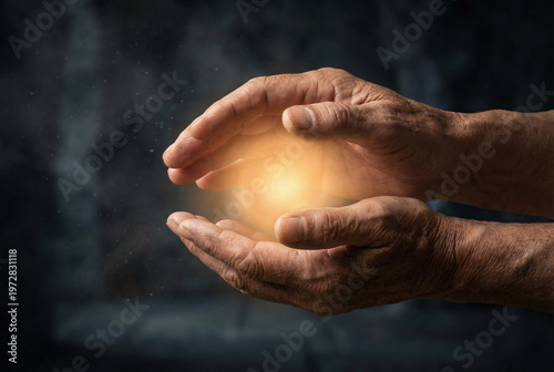 Hands holding a glowing sphere of light