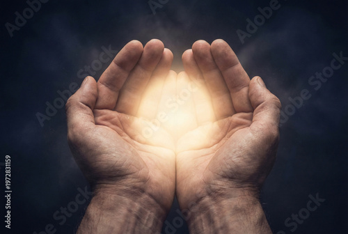 Hands holding a glowing sphere of light