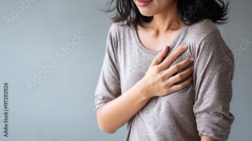 hand hold chest with heart attack symptoms, working hard have chest pain caused by heart disease, leak, dilatation, enlarged coronary heart, press on the chest with a painful expression