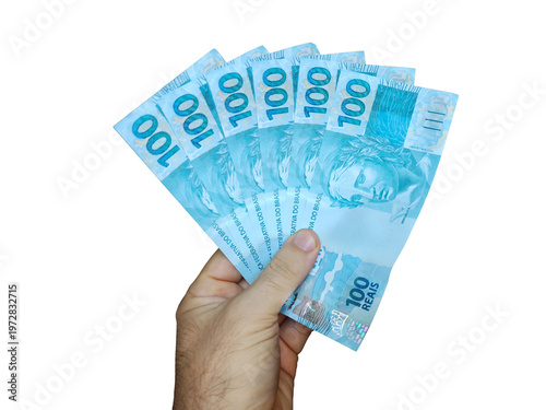 Hand holding Brazilian 100 reais banknotes isolated
