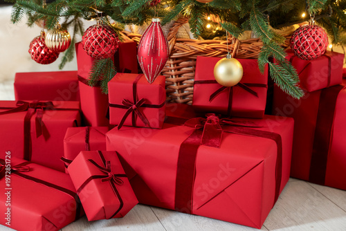 Many gift boxes under Christmas tree indoors, closeup
